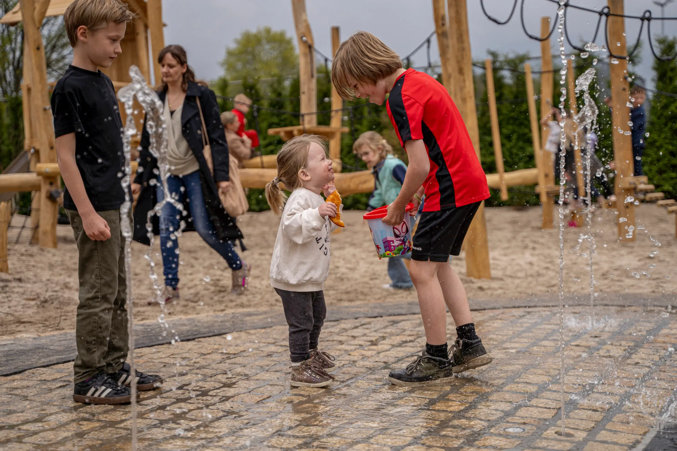 Kinderen die waterpret hebben in de speeltuin